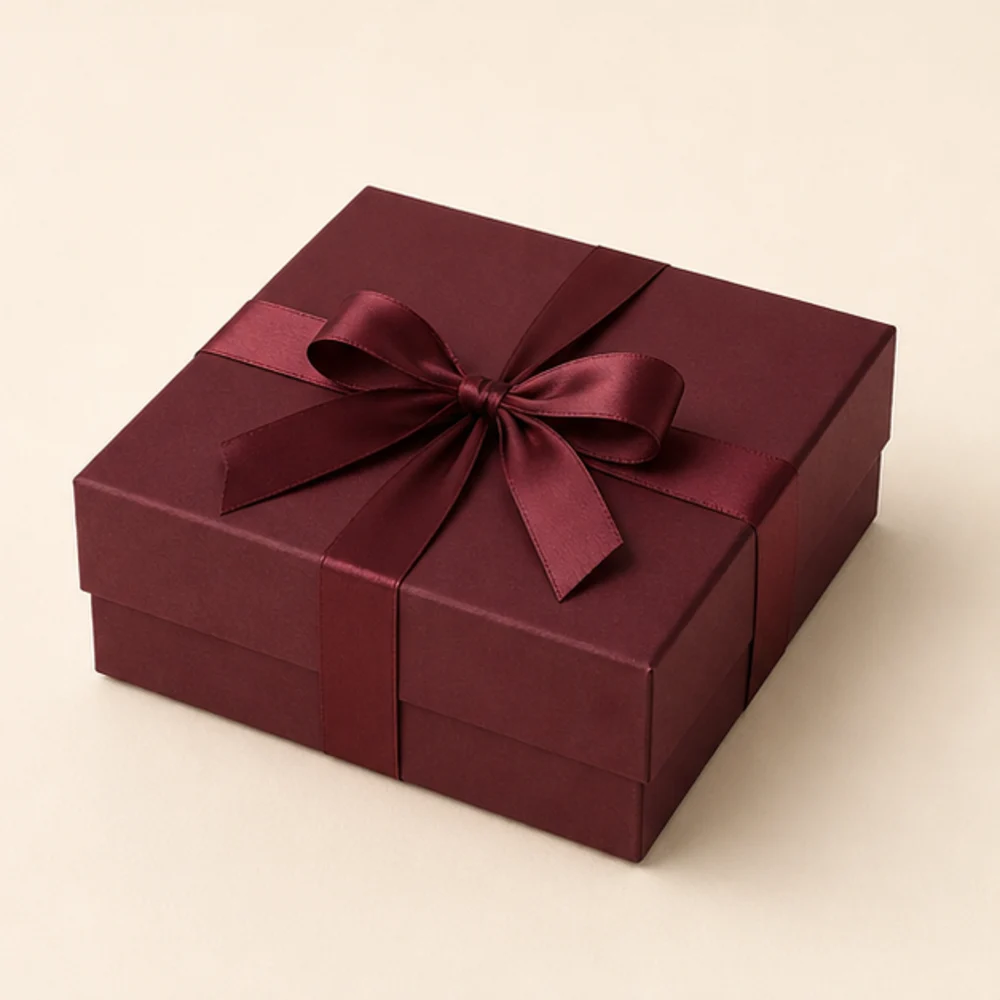Illustrative burgundy luxury gift box with ribbon