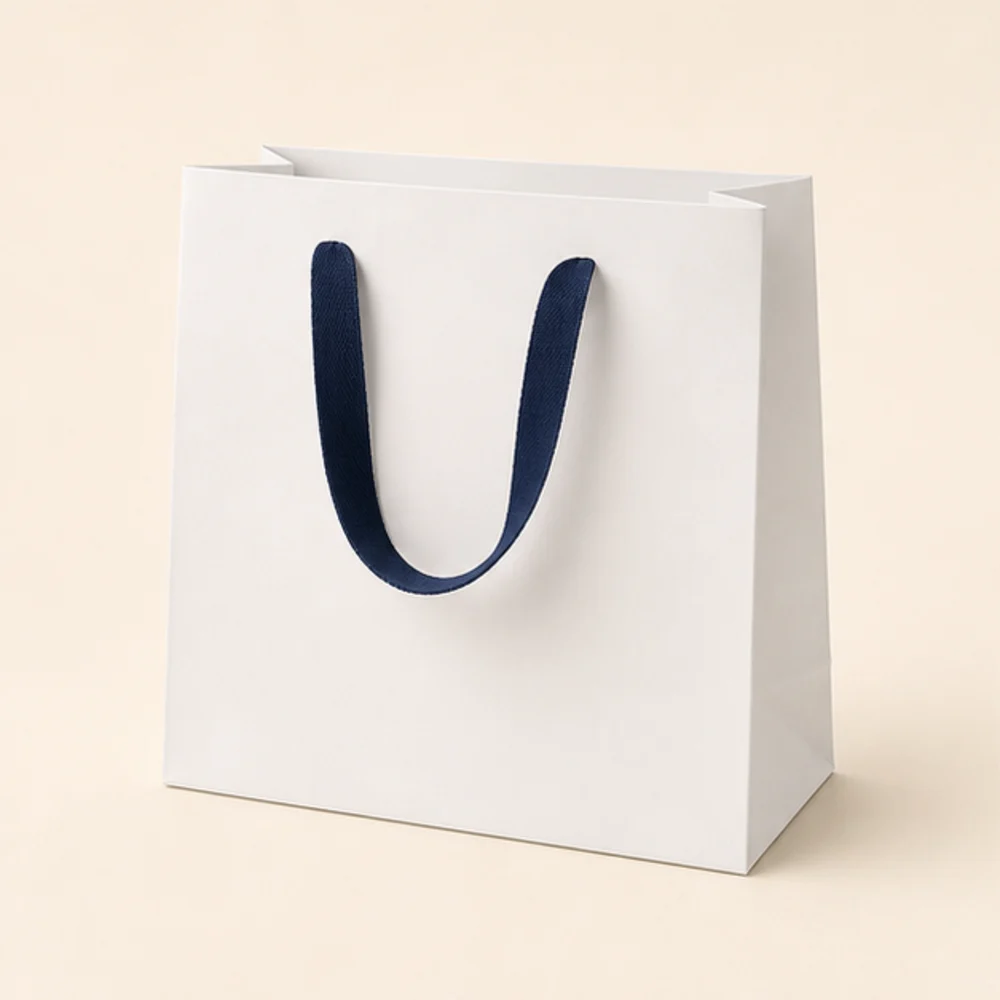 Illustrative white paper shopping bag with navy handles